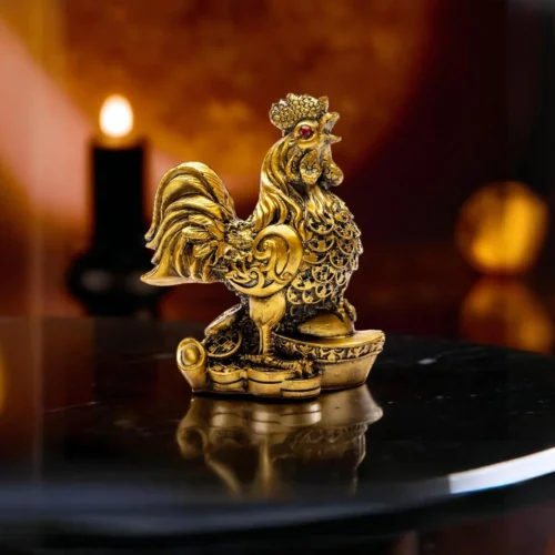 Golden Feng Shui Rooster statue standing on ancient coins, symbolizing wealth, protection, and career success